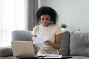 woman looking at financial paperwork