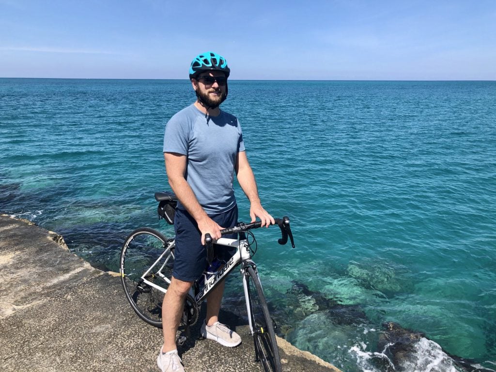 Dr. Berley biking by the ocean