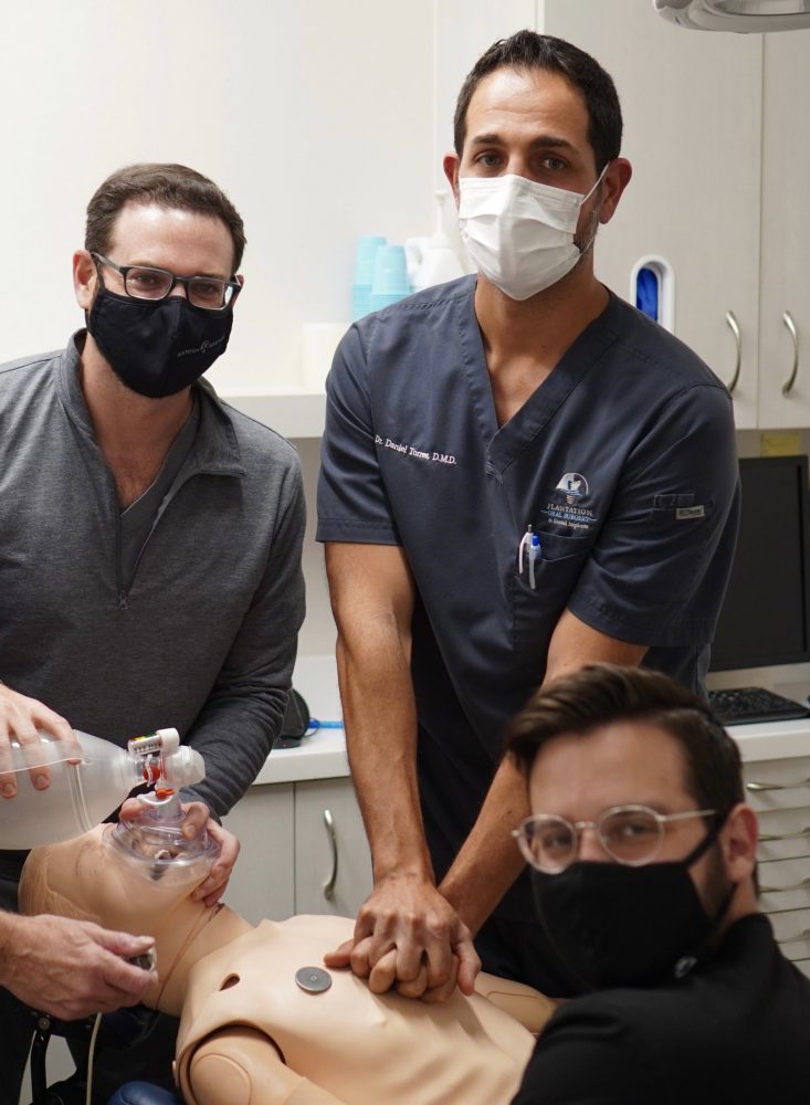 Oral surgeons doing anesthesia training on a fake person.